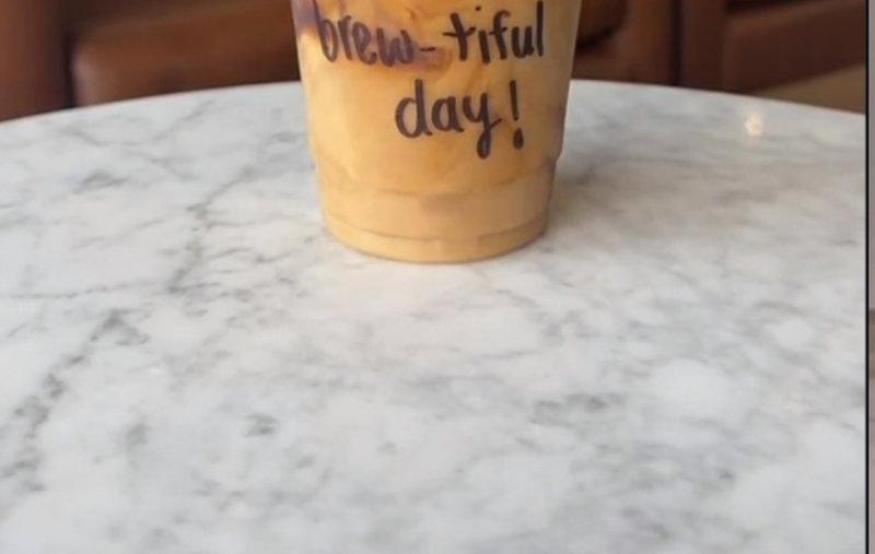An AMLA latte on a marble table
