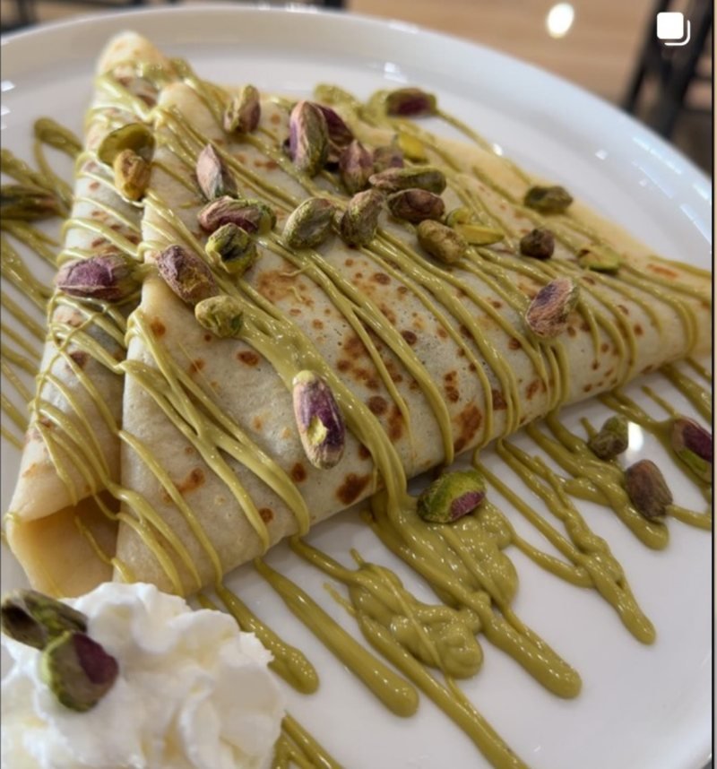 A made-to-order crepe with pistachio drizzle and crushed pistachios